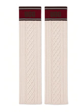 UGG knit socks laid flat, cream cable knit with maroon UGG cuff