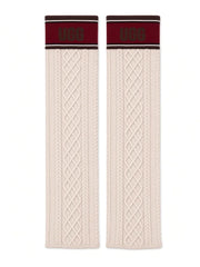UGG knit socks laid flat, cream cable knit with maroon UGG cuff